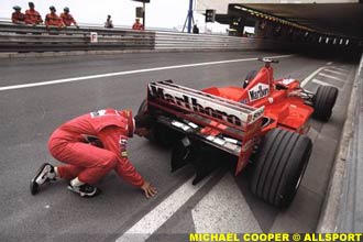 Schumacher inspects his ailing car, at Monaco in 1998