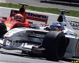 Michael Schumacher prepares to pass Olivier Panis