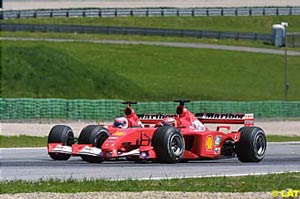 Michael Schumacher overtaking Rubens Barrichello on the outside