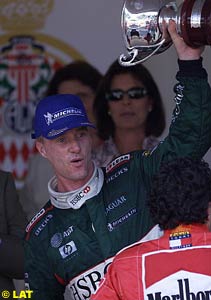 Eddie Irvine lifting the 3rd place trophy in Monaco