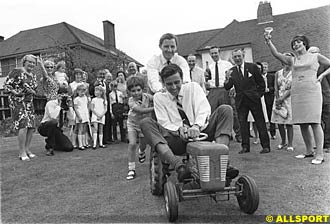 Clark fools around with Graham and Damon Hill, at a party thrown by Bette Hill