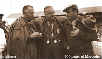 1954, The British GP: Alfred Neubauer in the centre flanked by drivers (left) Karl Kling and Juan Fangio