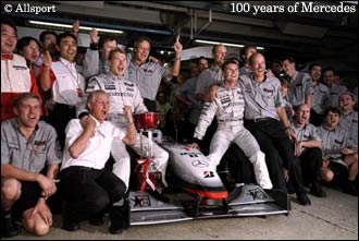 The McLaren-Mercedes team celebrate their double title triumph at Suzuka in 1998