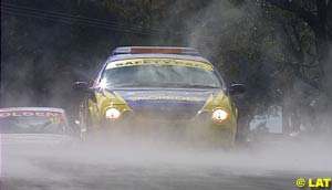 The safety car leads the field through the mist