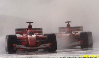 Barrichello and Schumacher plough through the field