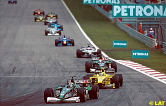 Eddie Irvine leads Heinz Harald Frentzen and Johnny Herbert at the Malaysian Grand Prix, Sepang, 2000.