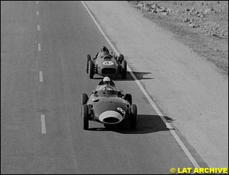 Stirling Moss (Vanwall VW5) leads Phil Hill (Ferrari Dino 246)