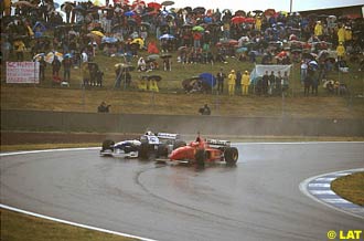 Michael Schumacher, Ferrari F310, passing Jacques Villeneuve, Williams FW18 Renault, 1996 Spanish Grand Prix.