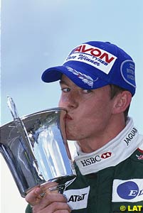 James Courtney kisses his winner's trophy