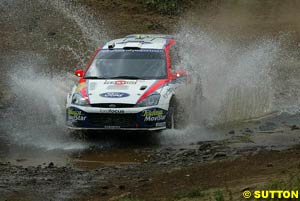 Colin McRae tackles a water splash, a rare but occasional sight on the Safari