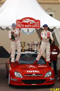 Sebastien Loeb and co-driver Daniel Elena celebrating prematurely on top of their Citroen Xsara
