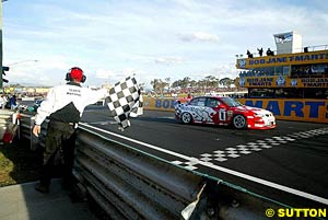 Mark Skaife takes the chequered flag to win Bathurst