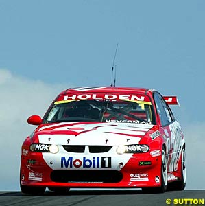 The winning car of Mark Skaife and Jim Richards drops down over Skyline