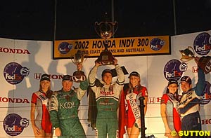 Late in the day for the podium, Mario Dominguez holding up the winner's trophy