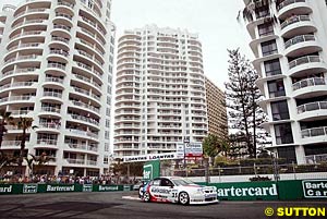 Race two and overall winner Jason Bargwanna drives between the high rises