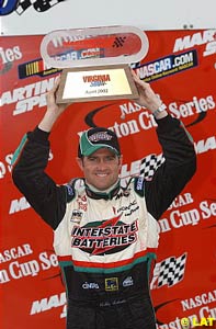 Bobby Labonte holds the winner's trophy up high