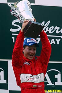 Ricardo Sperafico holds the winner's trophy aloft