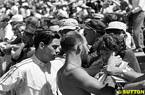 Clark and Stirling Moss sign autographs at Indy 1963