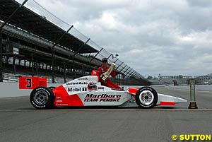 Helio Castroneves with his car and trophies