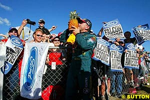 Russell Ingall kisses a pineapple after becoming 'Top Pineapple', the winner of the Queensland Raceway event