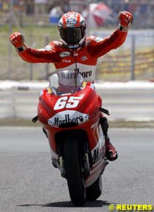 Winner Loris Capirossi celebrates Ducati's first MotoGP win