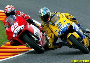 Ducati's Loris Capirossi tries to pass Honda rider Max Biaggi on the inside through a bend
