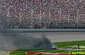 Rusty Wallace's car smokes after his car caught fire after an engine failure