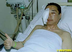 Kenjiro Shinozuka gives a thumbs up while recovering in hospital after his horrific accident