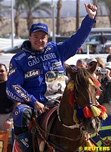 Motorcycle winner Richard Sainct on horseback