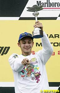 Valentino Rossi celebrates on the podium after winning the Malaysian Grand Prix, clinching the title