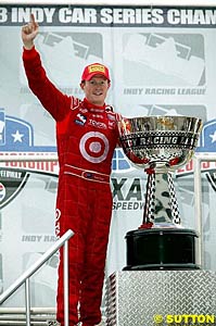 Scott Dixon stands alongside his championship trophy