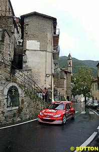 Gilles Panizzi gambled with tyre choice and won, finishing the rally in second place after rain fell