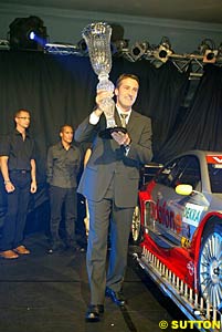 Bernd Schneider holding the 2003 DTM championship winner's trophy