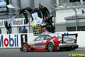 Bernd Schneider's team celebrates him winning the title after Schneider finished fourth at Hockenheim