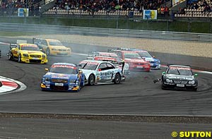 Christijan Albers gets pushed sideways by Martin Tomczyk at the start