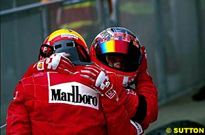 Barrichello hugs Schumacher at the end of the race