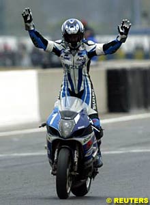 The winning Suzuki crosses the line