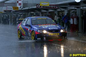 Marcos Ambrose creates a bow wave as he finally pits for wets