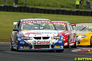 Greg Murphy holds off Mark Skaife and points leader Jason Bright early in the race