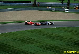 Montoya pushes Barrichello off the track