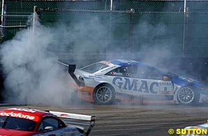 Alain Menu heads into the fence after contact with Peter Terting