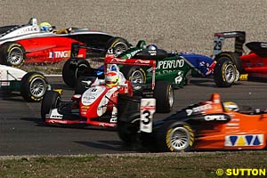 Ryan Briscoe, spun, centre, sits stranded at the start of race one as cars dive left and right to avoid him, before going on to win race two