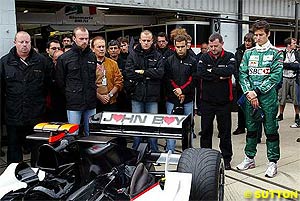 The Minardi team pay their respects to the late John Walton with a minute's silence and a special livery on the PS04B