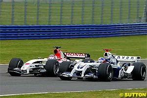 Montoya battles it out with Sato at the start