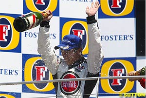 Takuma Sato on the podium at Indy