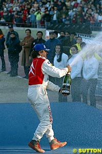 Carlos Sainz sprays the champagne after taking a record breaking win