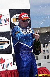Winner Paul Tracy sprays the champers