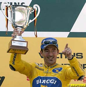 Max Biaggi celebrates with his winner's trophy