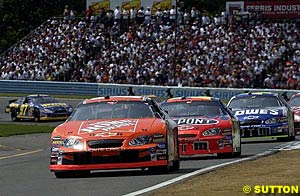 Winner Tony Stewart leads Jeff Gordon and Jimmie Johnson early in the race