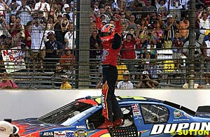 Jeff Gordon celebrates in front of the fans at the yard of bricks